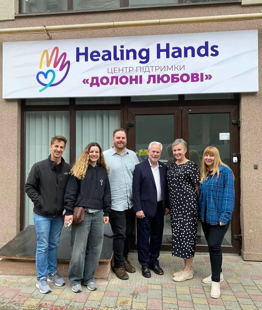 The team standing in front of the Healing Hands support center in Ternopil on opening day