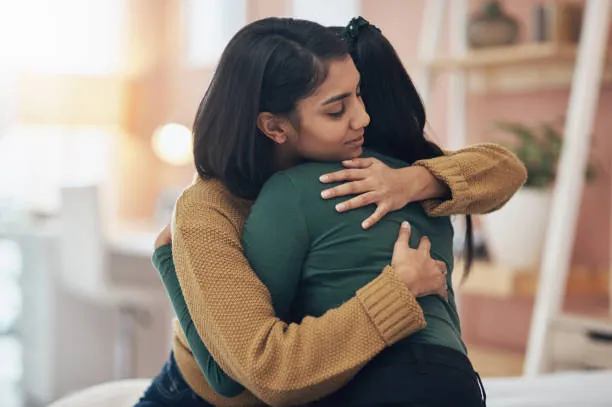 Two women holding each other